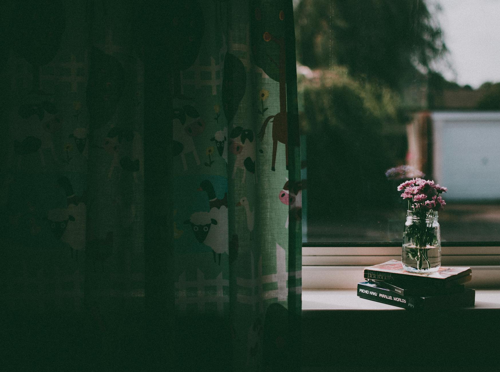 clear glass vase on book by the window